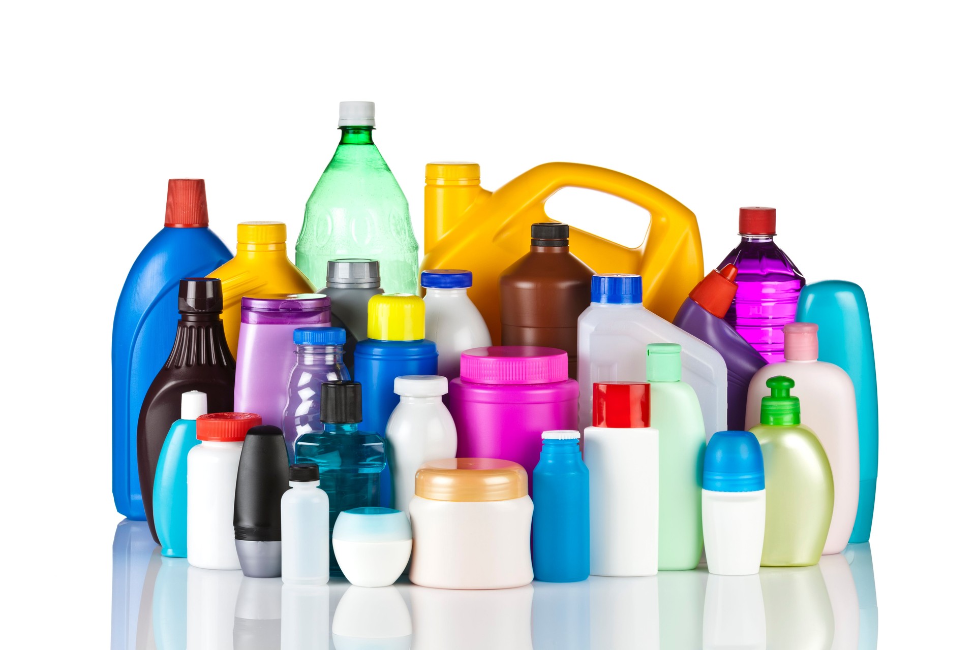 Large group of multicolored plastic bottles against white background